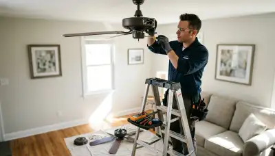 Electrician diagnosing ceiling fan wiring for a Bloomington, Indiana home repair service