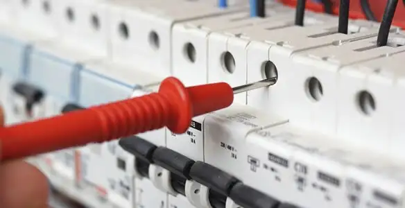 Electrical contractor testing circuit breakers during electrical repair in Solsberry, IN
