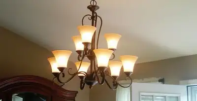 Classic ceiling chandelier installation with warm lighting in Bloomington, IN
