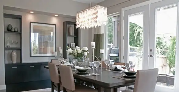 Elegant dining room chandelier installation above table in Bloomington, IN