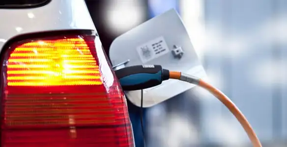 Electric car plugged into EV charger after professional installation in Bloomington, IN