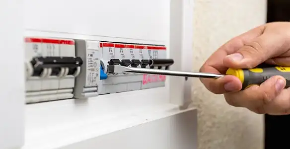 electrical panel upgrade service showing technician adjusting circuit breakers during system upgrade in Bloomington, IN