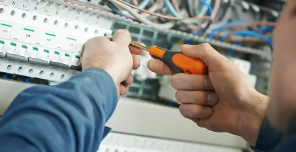 electrical service showing licensed electrician performing electrical panel maintenance and adjustments in Bloomington, IN