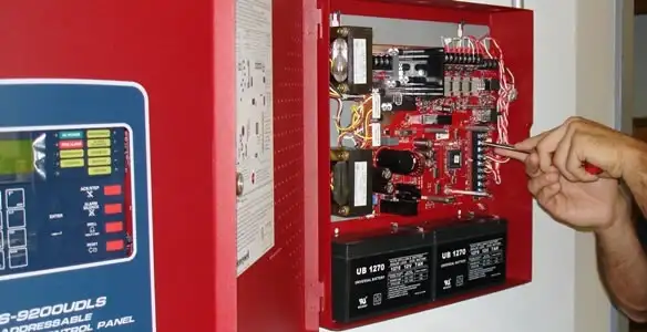 fire alarm installation service showing technician configuring fire alarm control panel in Bloomington, IN