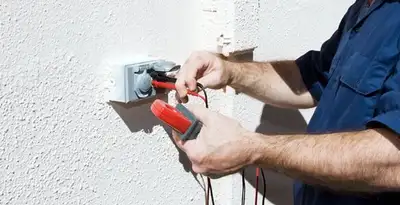 Electrician performing home electrical outlet and wiring inspection in Bloomington, IN