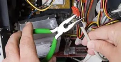 Licensed electrical contractor performing electrical repair with tools in Ellettsville, IN