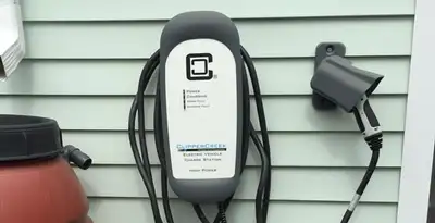 Outdoor electric vehicle charger installation on residential wall in Bloomington, IN
