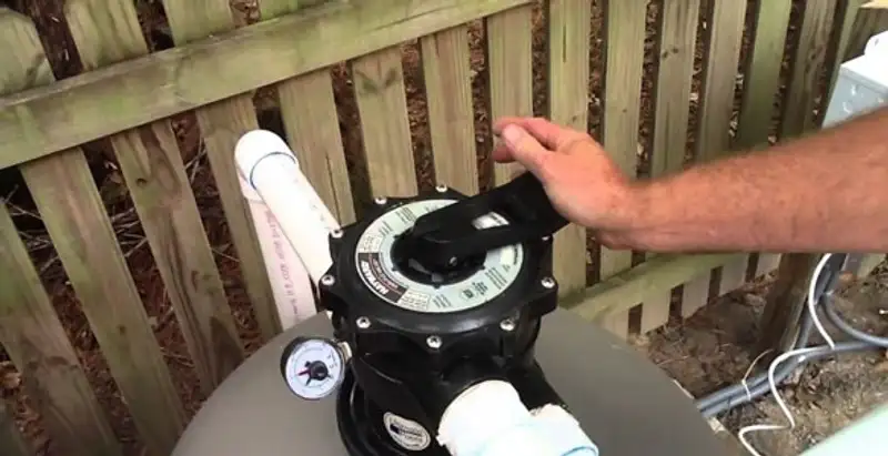 pool pumps service showing professional adjustment of pool pump control system in Bloomington, IN