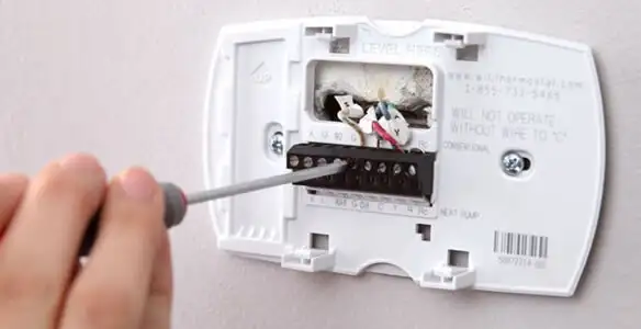 Thermostat installation service with proper wiring and secure wall mounting in Bloomington, IN