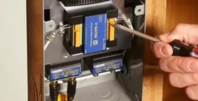 Whole home surge protection device being installed by a licensed electrician to protect electrical systems in Bloomington, IN